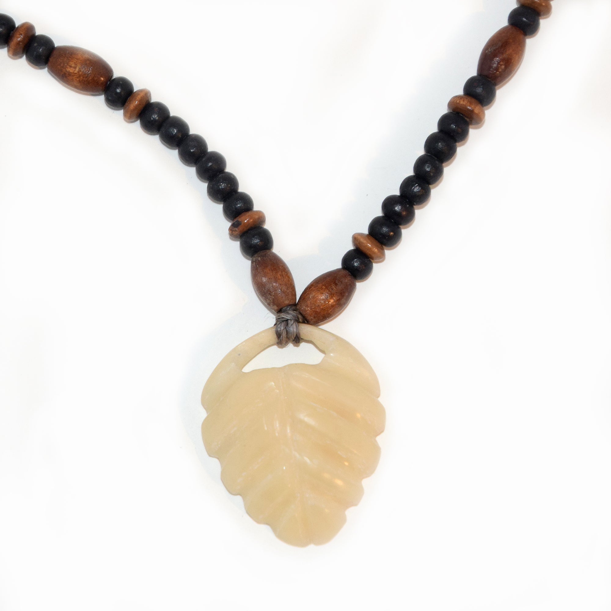 Carved tagua palm nut pendant and wooden bead necklace - made by an artisan from the Peruvian Amazon