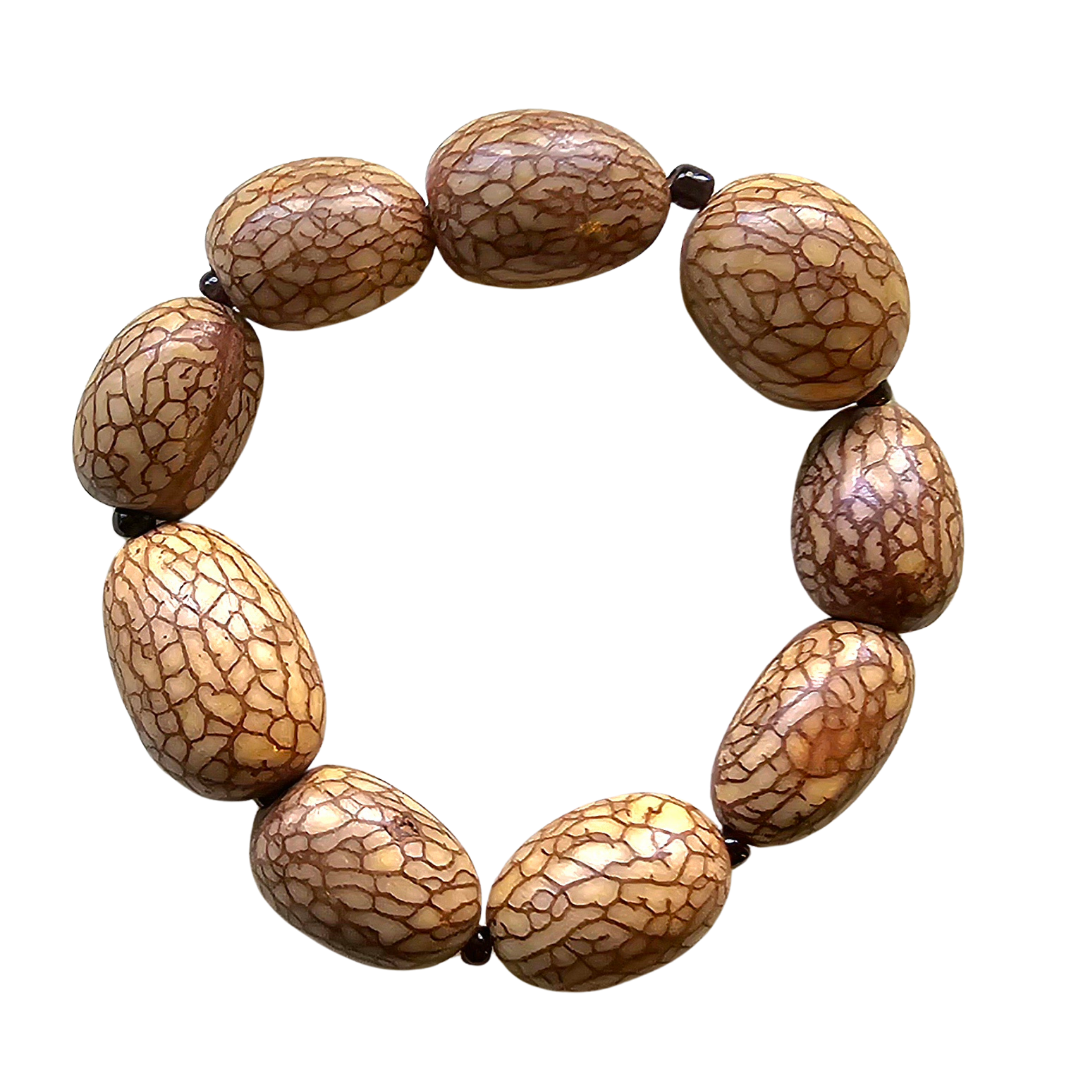 Polished ungurahui and cerebro palm seed bracelets made by Peruvian Amazon artisan