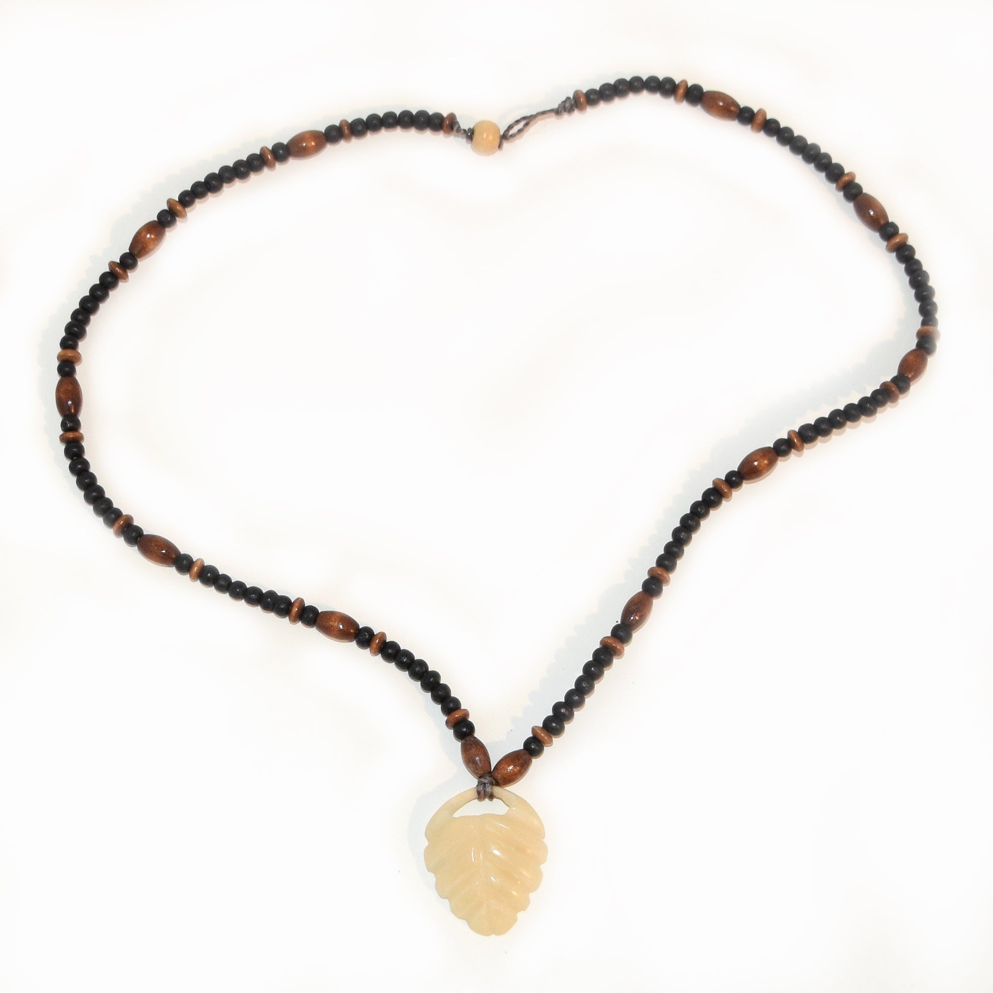 Carved tagua palm nut pendant and wooden bead necklace - made by an artisan from the Peruvian Amazon