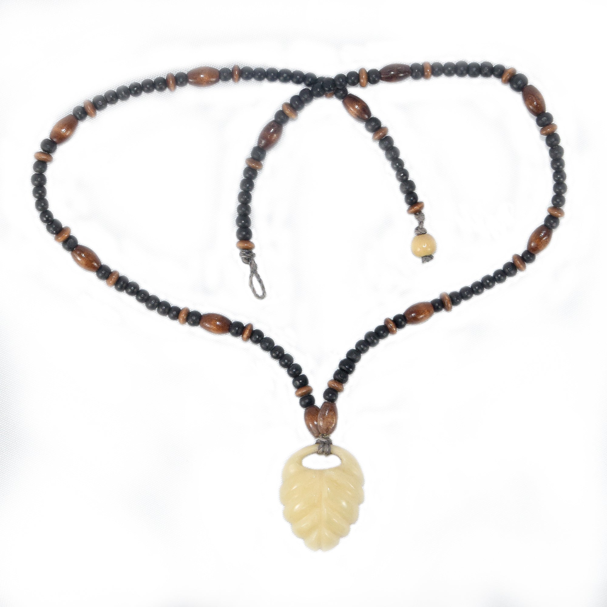 Carved tagua palm nut pendant and wooden bead necklace - made by an artisan from the Peruvian Amazon